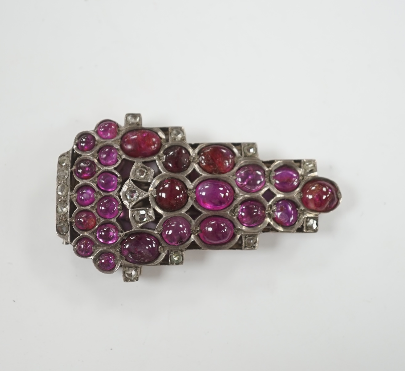 A 1920's? continental white metal cabochon ruby and rose cut diamond set clip brooch, 49mm.